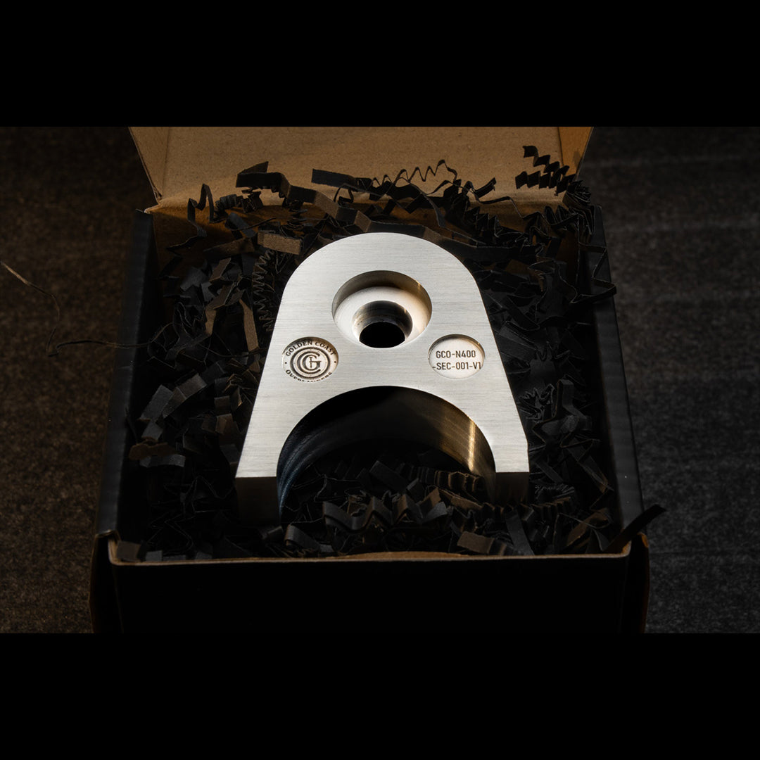 Golden Coast Overlanders 4th Gen Tacoma tailgate anchor retail packaging. Precision machined billet aluminum block in premium box.