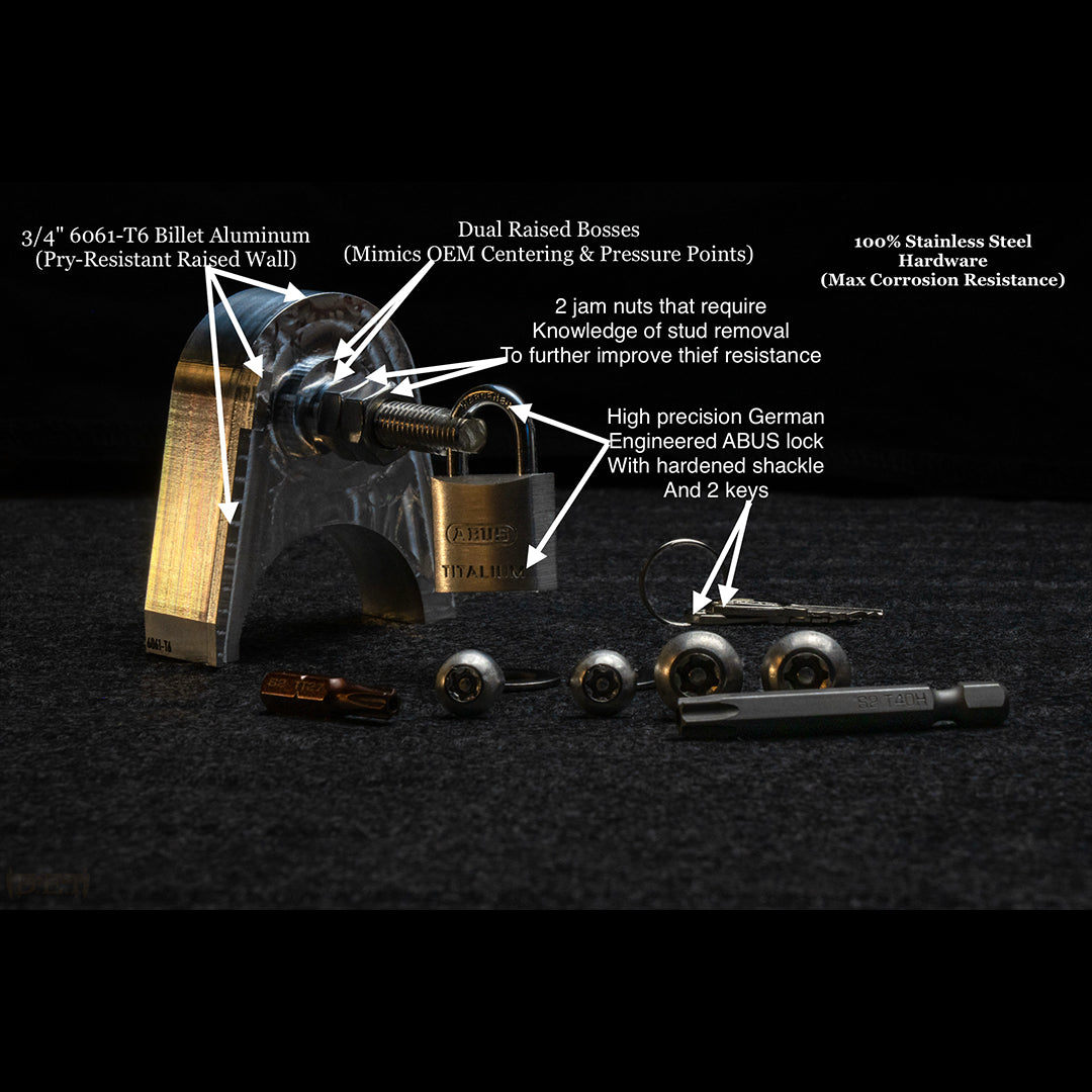 Backside of N400 Tacoma tailgate lock showing CNC machined dual raised bosses, stainless hardware, and ABUS padlock.